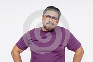 A middle aged man shrugs while looking confused and perplexed, in a slightly agitated mood. Wearing eyeglasses and a purple waffle