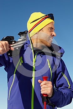 Middle Aged Man On Ski Holiday In Mountains