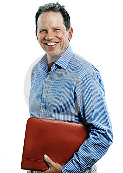 Middle-aged man smiling and holding binder isolated on white