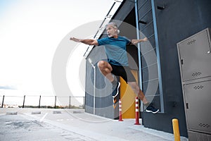 Middle-aged man in sportswear warming up before training.