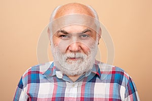 Middle aged man on studio isolated background. Close up portrait of grey-haired mature senior man. Older grandfather