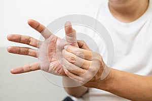 Middle-aged man suffering from De quervain`s disease,numbness or beriberi of palms and fingertips,male patient with trigger finge photo