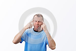 Middle aged man suffering headache and depression isolated on white background. Middle aged man holding his head with hands,