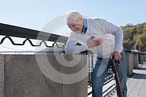 Middle aged man suffering from pain in the street