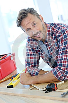 Middle-aged man with tools working on home improvement