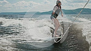A middle-aged man tries to cope with a wakesurf. A man funny falls into the water. Ridiculous and funny case on the