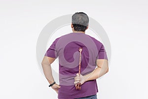 A middle aged man using a backscratcher to scracth and relieve an itch on his upper back. Rear view, isolated on a white