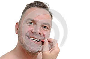 Middle aged man using interdental brush