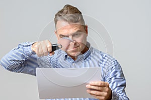 Middle aged man using a magnifying glass