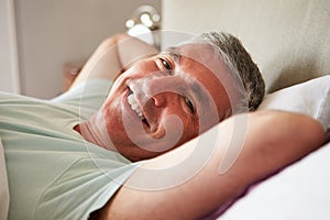Middle Aged Man Waking Up In Bed