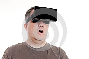 Middle aged man wearing VR virtual reality headset is stunned