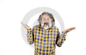 Middle-aged man with white beard and mustache raises his hands on a white background