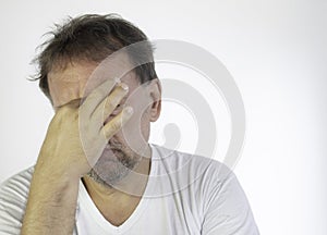 Middle-aged man with white T-shirt and quarantined boredom. Depression and anguish for social isolation