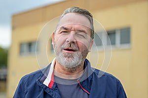 Middle aged man winking in a close up