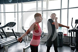 Middle-aged man and woman preparing for fitness class