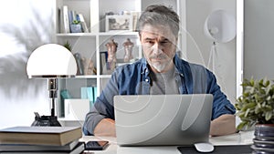 Middle aged man working with computer at home