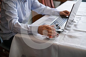 Middle-aged man is working with on laptop at home