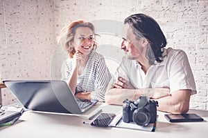 A middle-aged man and a young woman are sitting at a table with