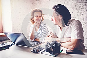 A middle-aged man and a young woman are sitting at a table with