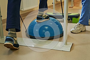 Middle-aged patient exercising in neurological rehabilitation facility