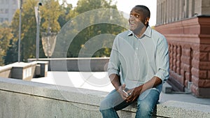 Middle-aged senior mature adult ethnic African American man male businessman entrepreneur sitting outdoors in city