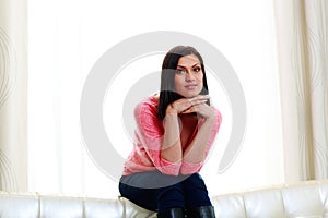 Middle-aged thoughtful woman sitting on the sofa near