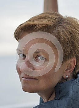 Middle aged white tanned woman outdoor portrait