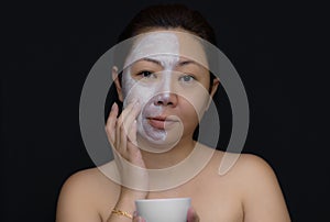 A middle-aged woman Asians are happy with a face mask for skin c photo
