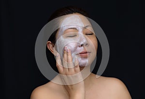 A middle-aged woman Asians are happy with a face mask for skin c photo