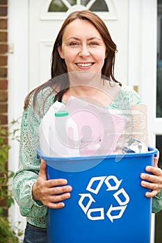 Middle Aged Woman Carrying Recycling Bin