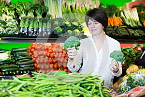 Middle aged woman choosing vegetables