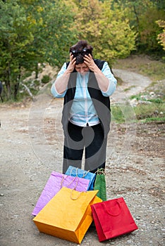 Middle-aged woman with colotful shopping bags