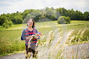 Middle aged woman with cornflowers and poppies