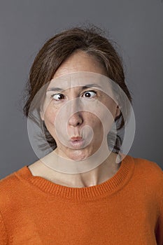 Middle aged woman with cross-eyed funny face for humor