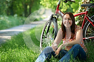 Middle Aged Woman On Cycle Ride In Countryside