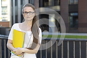 Middle aged woman with documents in hands. smart business lady, businesswoman, thoughtful teacher, pensive lecturer