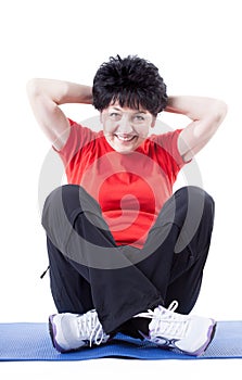 Middle-aged woman doing sit-ups photo