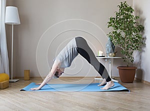 Middle aged woman doing yoga indoors