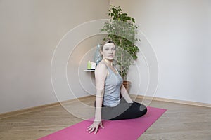 Middle aged woman doing yoga indoors