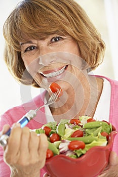 Middle Aged Woman Eating A Fresh Green Salad