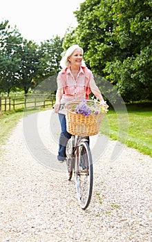 Middle Aged Woman Enjoying Country Cycle Ride