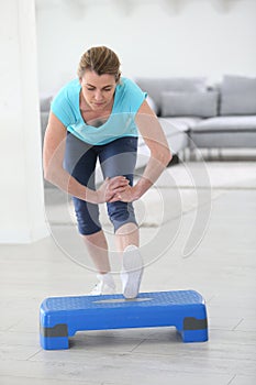 Middle-aged woman excercising at home