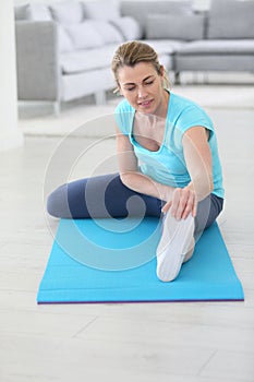 Middle-aged woman excercising and stretching