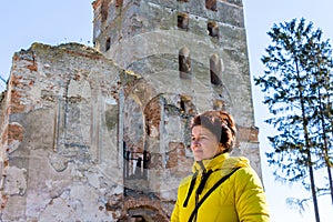 Middle-aged woman during an excursion to the old castle_