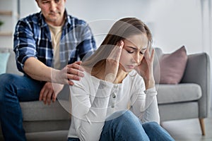 Middle-aged woman feeling stressed, facing health issues, having problem, her husband supporting her at home