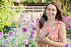 Middle Aged Woman Gardening At Home