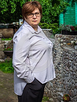 Middle-aged woman with glasses sad in the Park