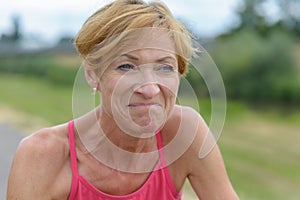 Middle-aged woman grimacing with a wry expression