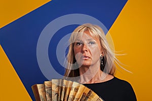 Middle-Aged Woman Having A Hot flash, Holding a Fan