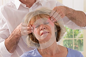 Middle Aged Woman Having Temples Massaged